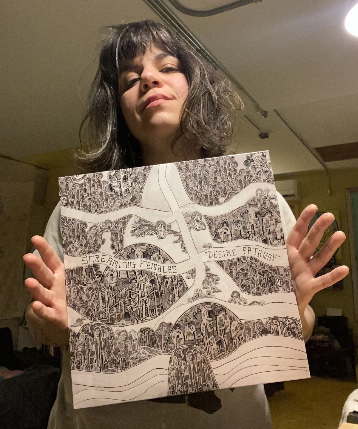 Marissa Paternoster holding a vinyl copy of Desire Pathway